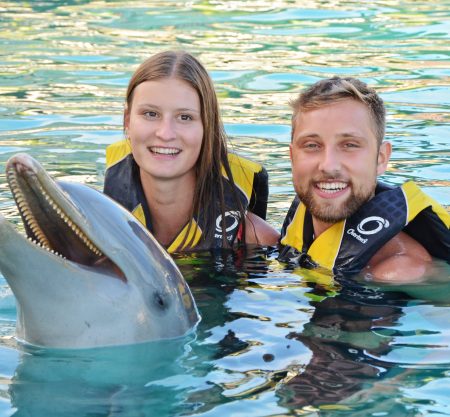 Guest swimming with a dolphin at Ocean World