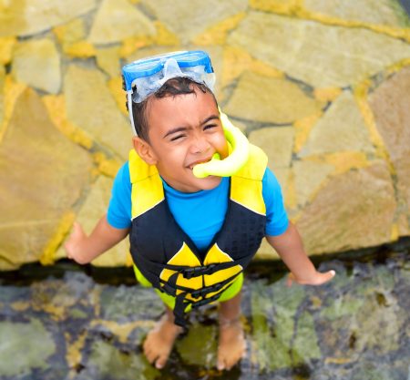 Child snorkeling in the tropical reef aquarium